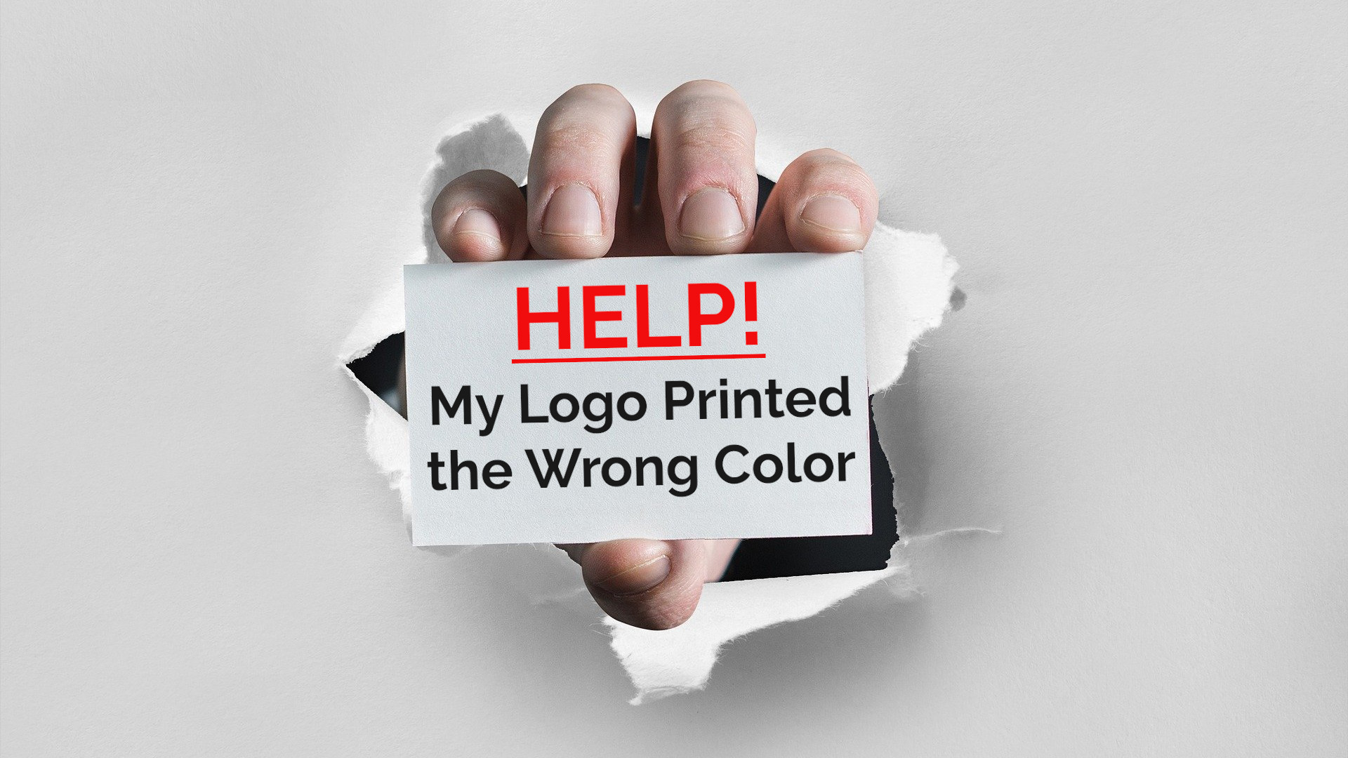 An image of a hand bursting through paper with the text 'Help! My Logo Printed the Wrong Color'